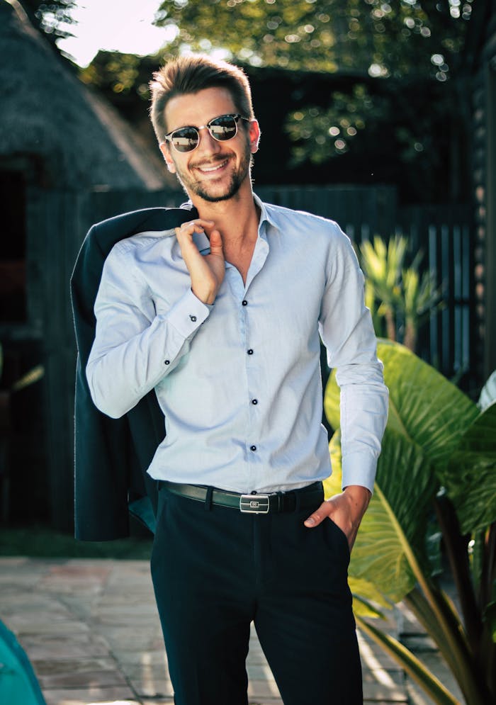 services-02 Confident young man in a stylish suit outdoors, exuding charm and elegance.
